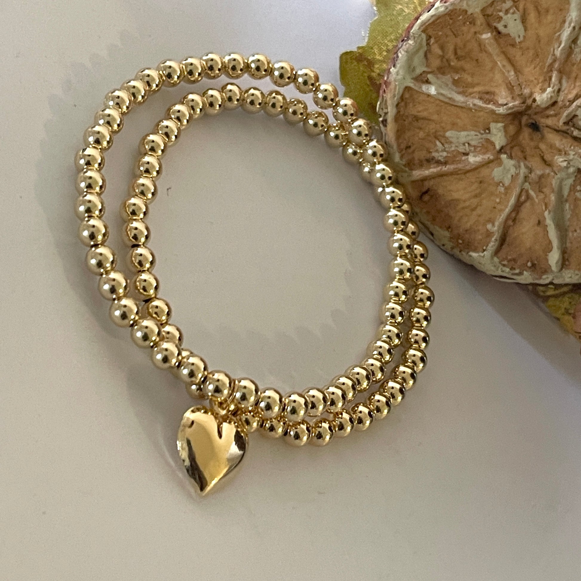 14k Solid Gold Heart Charm Bead Bracelet on wrist