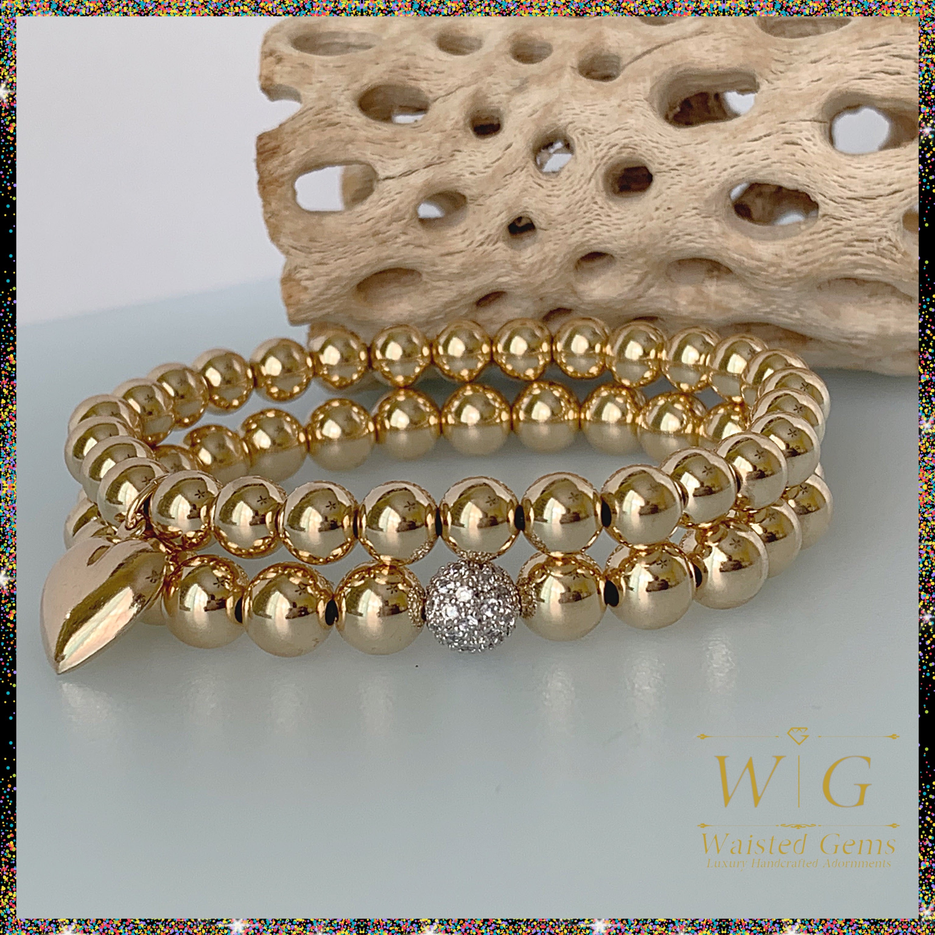 Solid gold heart charm bracelet detail